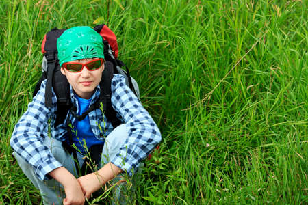A boy teenager with knapsack posing outdoor. Tourism, active life.の写真素材