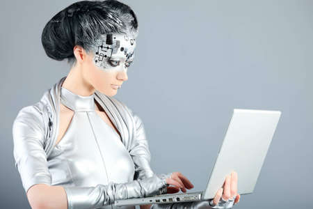 Shot of a futuristic young woman with a laptop. の写真素材