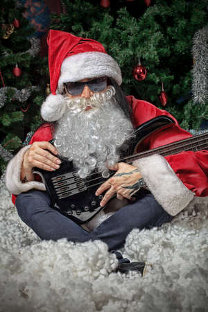 Portrait of a singing Santa Claus with electric guitar. Christmas.の写真素材