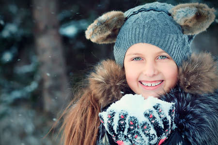 Cute girl at a winter park. の写真素材