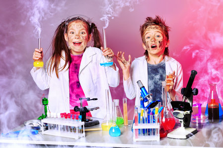 Two children making science experiments. Education.