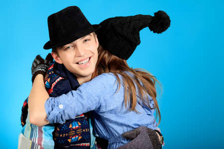 Portrait of a happy young couple in warm clothes.の写真素材