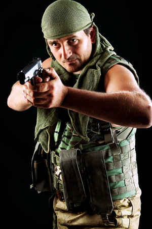 Shot of a conceptual soldier painted in khaki colors. Over black background.