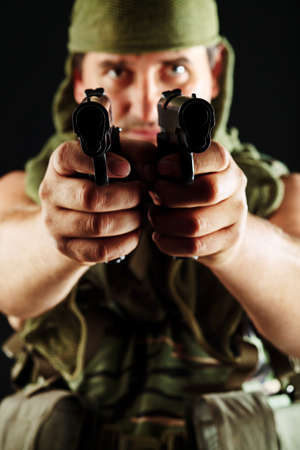 Shot of a conceptual soldier painted in khaki colors. Over black background.の写真素材
