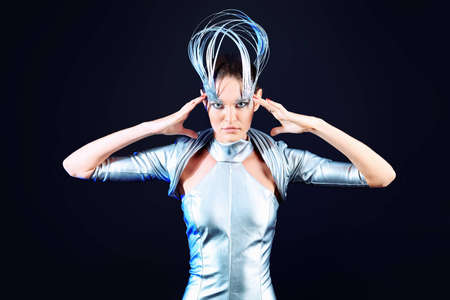 Fashion shot of a beautiful young woman over black background.の写真素材