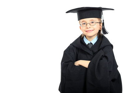 Portrait of a cute boy in a graduation gown. Education. Isolated over white.の写真素材