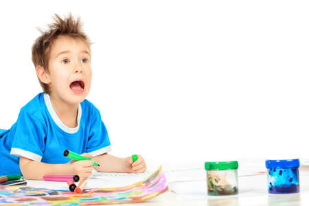 Portrait of a funny boy enjoying his painting. Education.の写真素材