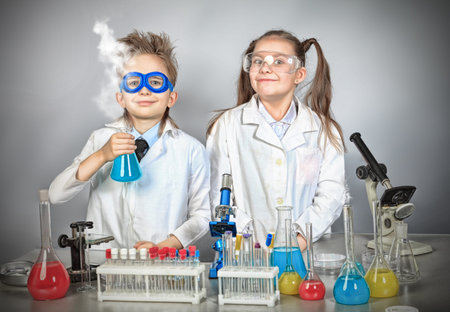 Two children making science experiments. Education.