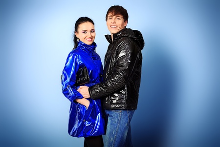 Couple of fashion models in winter, spring clothes posing at the studio.の写真素材