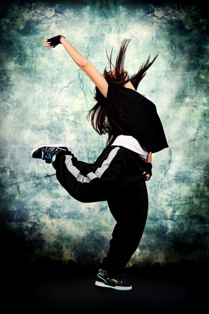 Modern teenage girl dancing hip-hop at studio.の写真素材