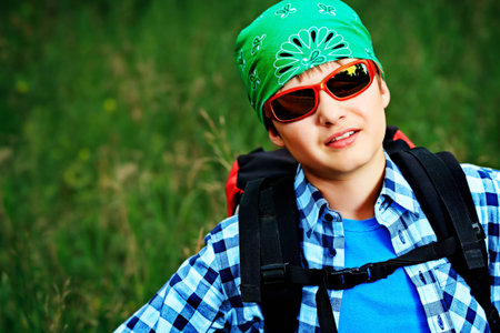 A boy teenager with knapsack posing outdoor. Tourism, active life.