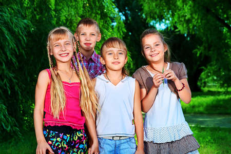 Group of cheerful children in a summer park.の写真素材