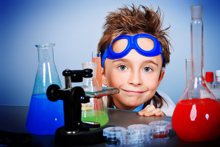 Little boy is making science experiments. Education.