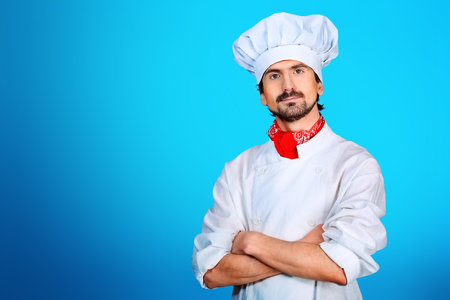 Portrait of a man cook posing  in a studio.