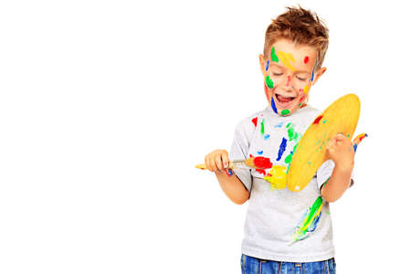 Portrait of a little boy enjoying his painting. Education. Isolated over white background.の写真素材