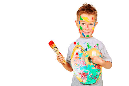 Portrait of a little boy enjoying his painting. Education. Isolated over white background.の写真素材