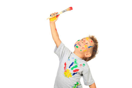 Portrait of a little boy enjoying his painting. Education. Isolated over white background.の写真素材