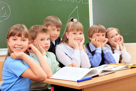 Happy schoolchildren at a classroom. Education.の写真素材