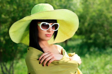 Portrait of a beautiful young woman in sunglasses posing outdoor.の写真素材