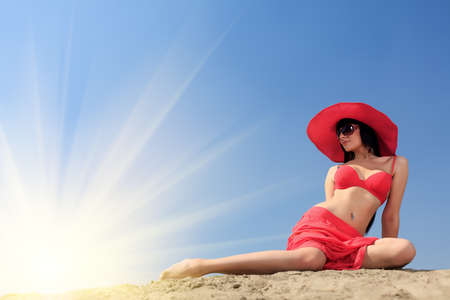 Beautiful young woman in bikini on a sunny beach.の写真素材