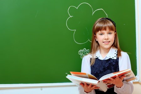 Portrait of a smiling schoolgirl in a classroom.