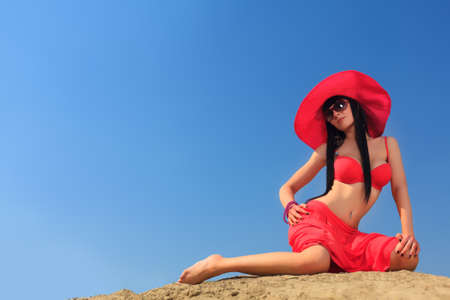 Beautiful young woman in bikini on a sunny beach.の写真素材