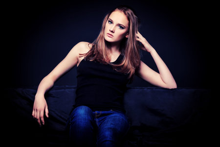 Fashion shot of an attractive young woman posing at studio.