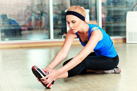Young sporty woman doing exercises in the gym centre.