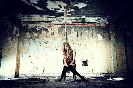 Beautiful lonely woman in the old house.