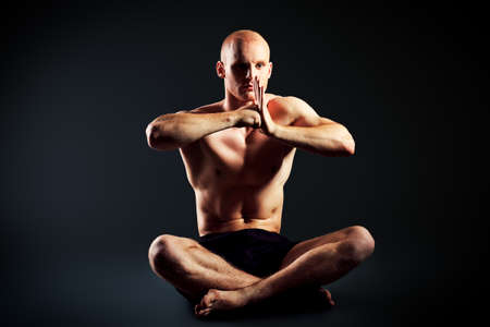 Portrait of a handsome muscular young man. Over black background.の写真素材
