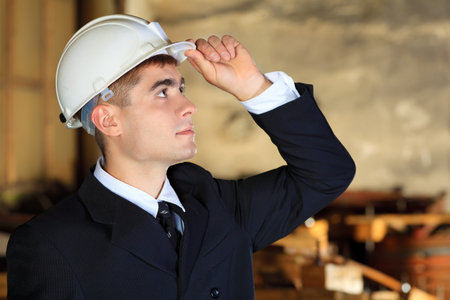 Industrial theme: businessman at a manufacturing area.