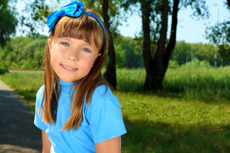Portrait of a cute smiling girl outdoor.の写真素材
