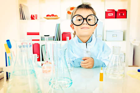 Cute boy is making science experiments in a laboratory. Education.の写真素材