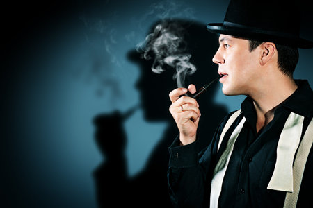 Portrait of a retro detective in pot hat smoking his pipe.