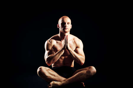 Portrait of a handsome muscular young man. Over black background.の写真素材