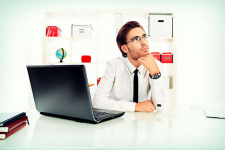 Handsome businessman is dreaming at the office.の写真素材