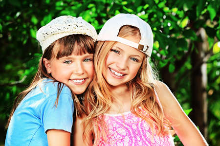 Two cheerful girls at the summer park.の写真素材