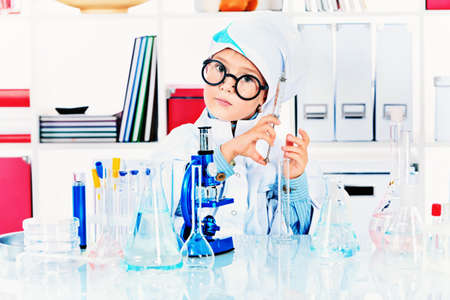 Cute boy is making science experiments in a laboratory. Education.の写真素材