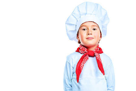 Portrait of a little kitchen boy in a white uniform. Isolated over white background.の写真素材