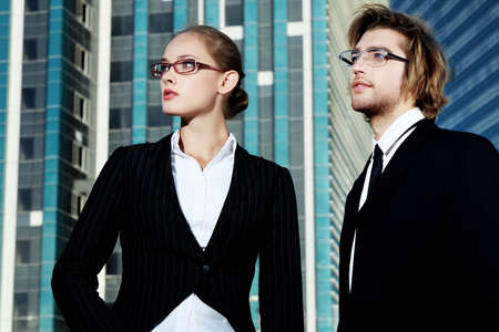 Business people standing in the city and purposefully looking away.の写真素材