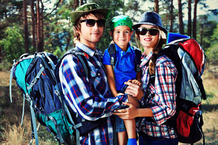 Happy parents hiking with their little son.の写真素材
