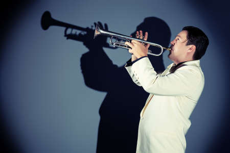 Portrait of a musician playing the trumpet at studio. の写真素材