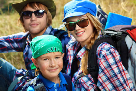 Happy parents hiking with their little son.の写真素材