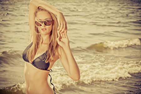 Romantic beautiful woman sunbathing on a seaside.の写真素材