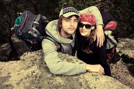 Couple of tourists at the top of a mountain with a feeling of freedom.