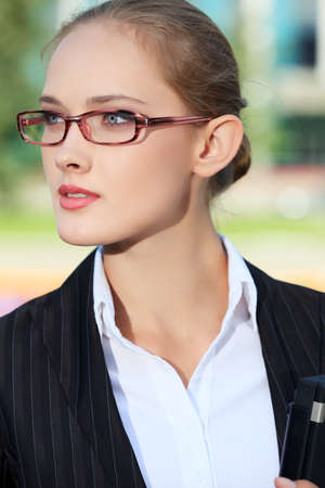 Portrait of a business woman standing in the big city and purposefully looking away.の写真素材