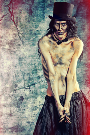 Gloomy vampire standing at the night background. Halloween.