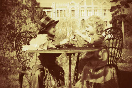 Cute children having a rest at a park. Retro style.の写真素材