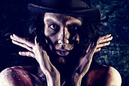 Gloomy vampire standing at the night background. Halloween.