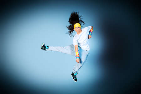 Young woman dancing hip-hop at studio.の写真素材